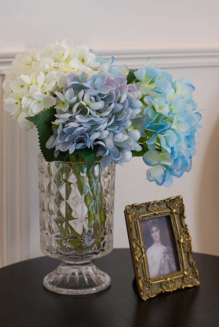 Detail of table with flowers and decorative picture