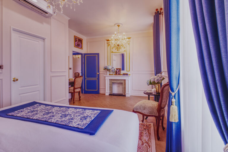 Chambre supreme, view from bed towards entrance of room showing dressing table and decorative fireplace