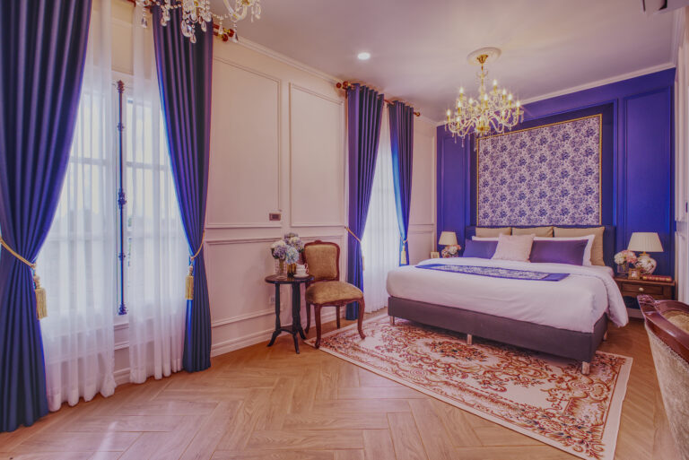 Largest luxurious bedroom overview, with 2 windows, make up table, decorate fireplace and attached bathroom