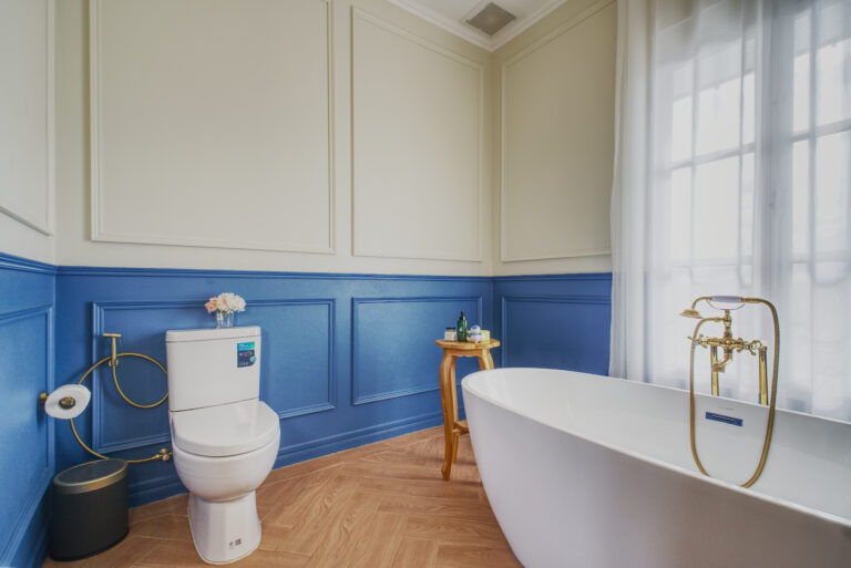 Bathroom with bathtub, view towards toilets