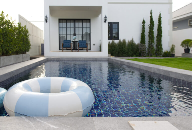 View of swimming pool towards the house and sitting area with entrance to living room