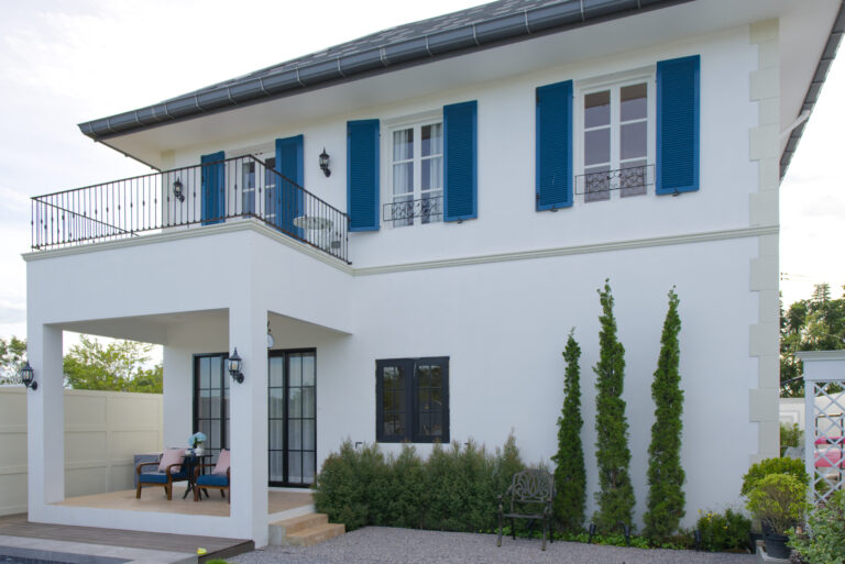 Perspective of the building from garden showing terrace and sitting, plants, swimming pool...