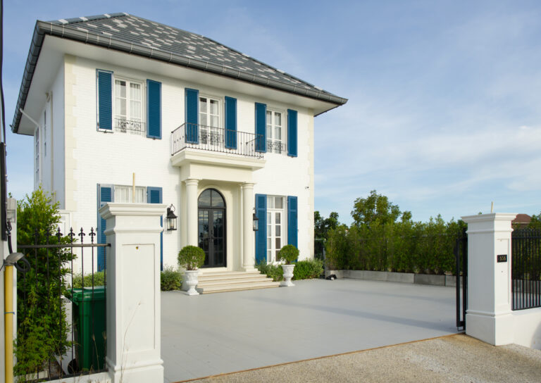 House overview from street showing gate, area for parking and property