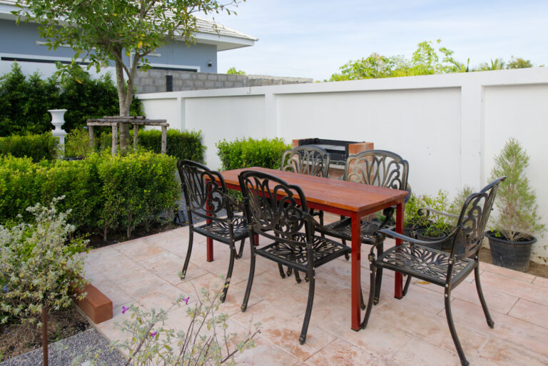 Barbecue and sitting area with table in garden