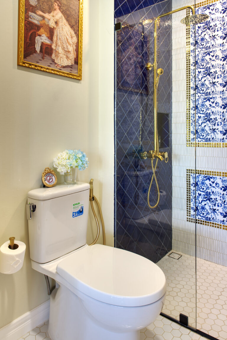 Bathroom connected to living room and bedroom showing shower area and toilets