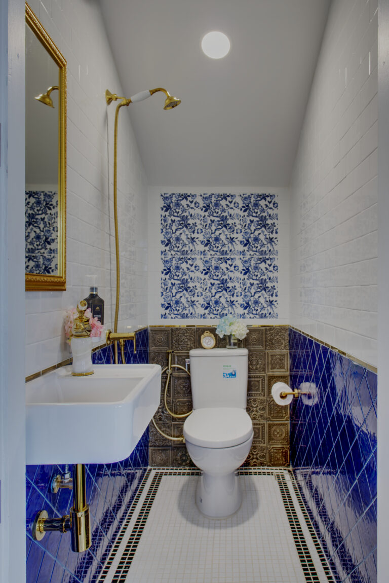 View of bathroom located under the stairs