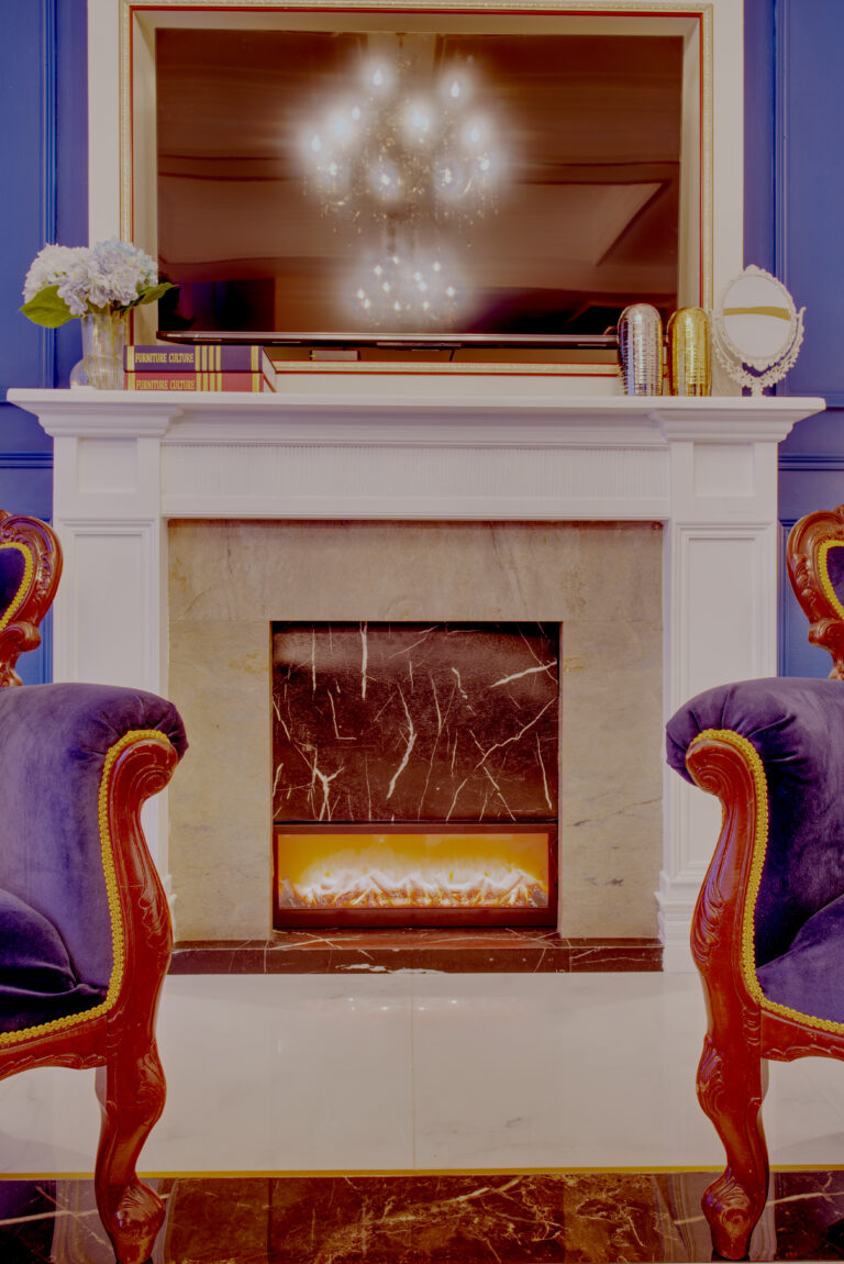 Focus on the decorative fireplace in action in the living room area