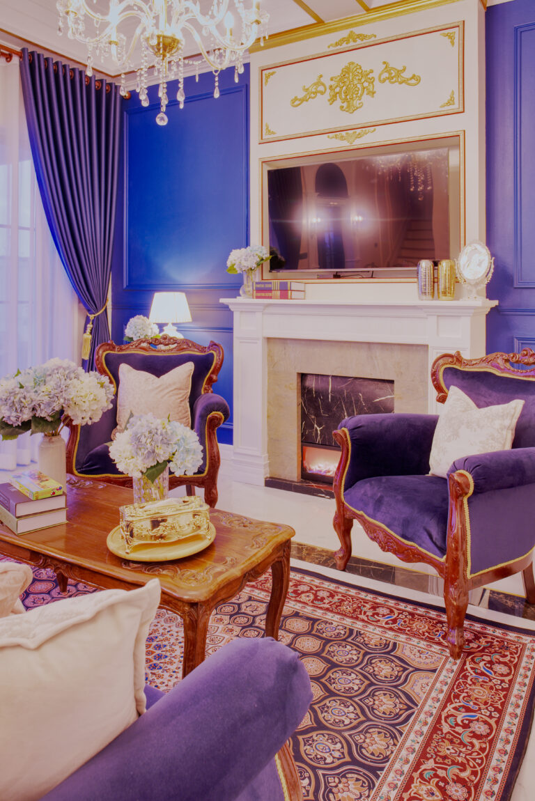 Living room area with armchairs, decorative fireplace and TV